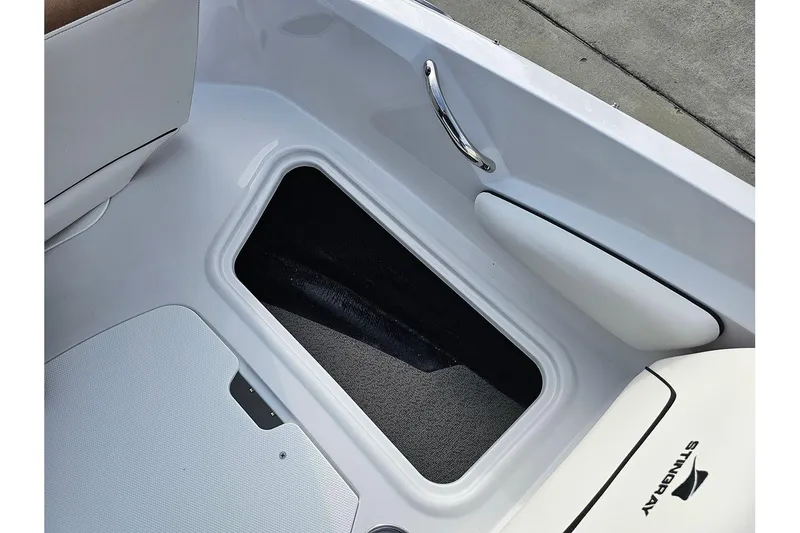 Slide: The Image of 2026 Stingray 191 DC boat interior with storage compartment and speakers. - 23