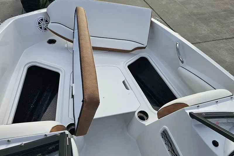 Slide: The Image of 2026 Stingray 191 DC boat interior storage compartment with sleek white finish and chrome handle. - 24