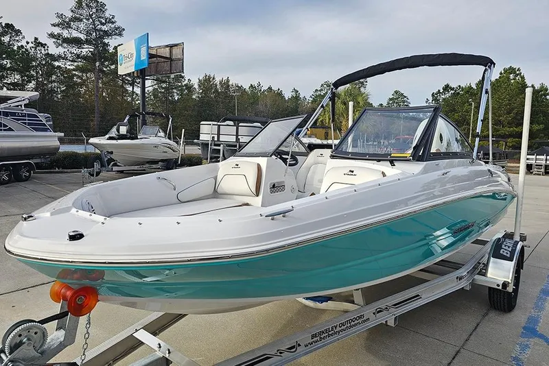 Slide: The Image of 2026 Stingray 191 DC boat displayed outdoors, featuring sleek white design and spacious seating. - 4