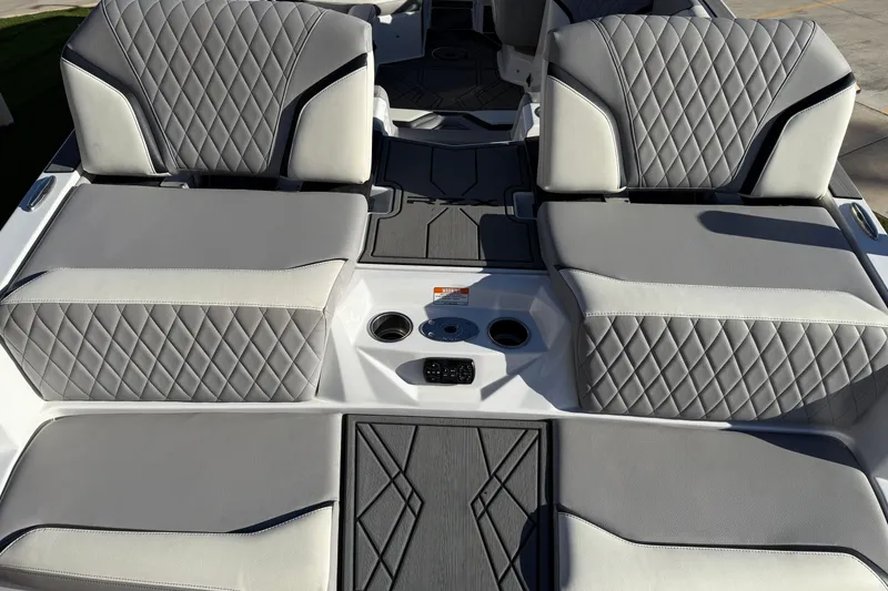 Slide: The Image of 2022 Tigé 24RZX boat interior with diamond-stitched gray and white seating. - 11