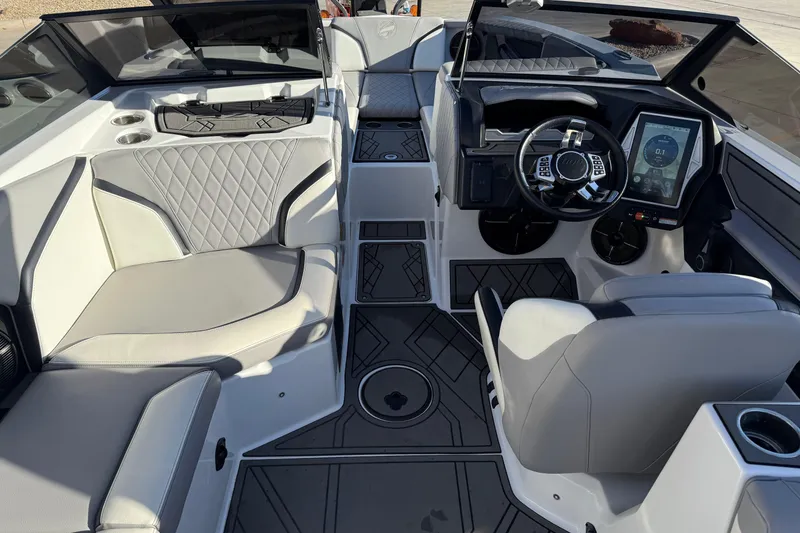Slide: The Image of 2022 Tigé 24RZX boat interior with modern dashboard and luxurious seating. - 16