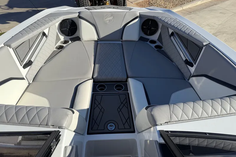 Slide: The Image of 2022 Tigé 24RZX boat interior with gray quilted seating and cup holders. - 19