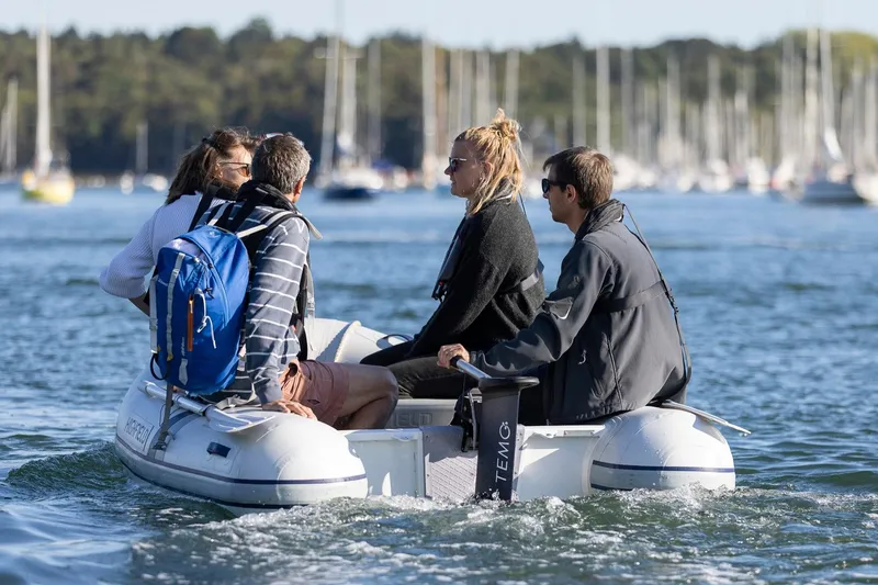 Slide: The Image of Four people on a Highfield Roll-Up 230 KAM inflatable boat, 2026 model. - 5