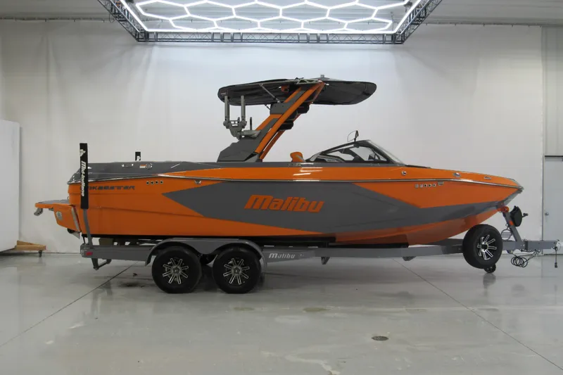 The Image of 2026 Malibu Wakesetter 23 LSV boat in vibrant orange and gray on trailer. - 0