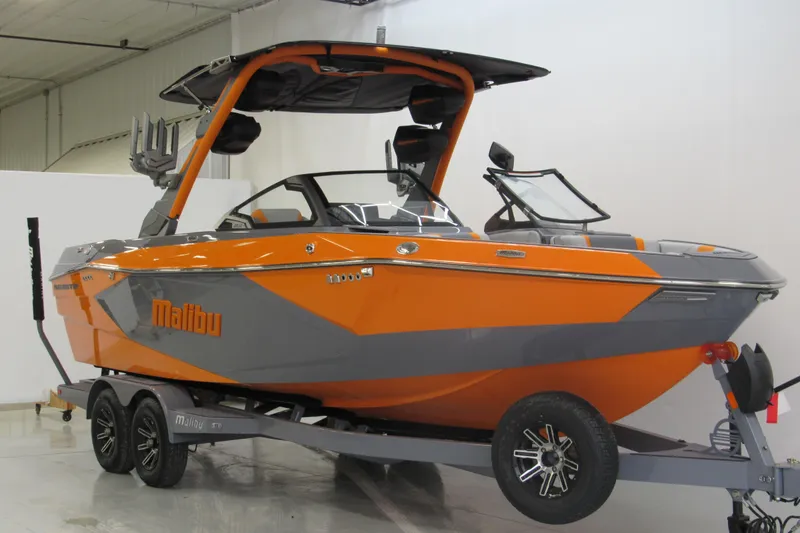 Slide: The Image of 2026 Malibu Wakesetter 23 LSV boat in orange and gray on trailer. - 1