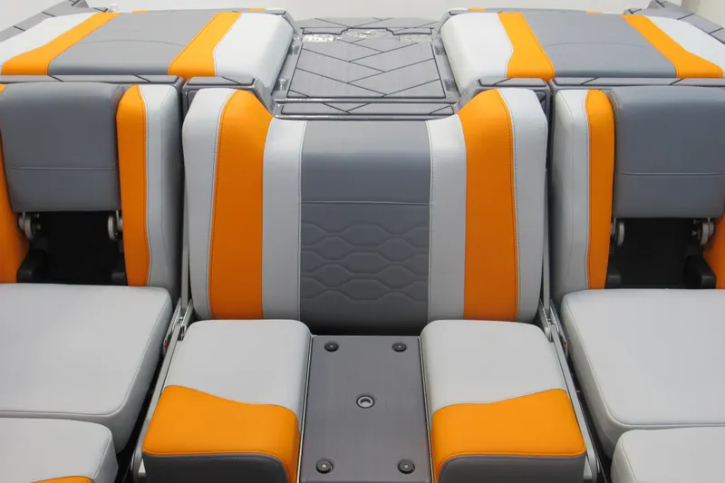 Slide: The Image of 2026 Malibu Wakesetter 23 LSV interior with orange and gray seating design. - 10