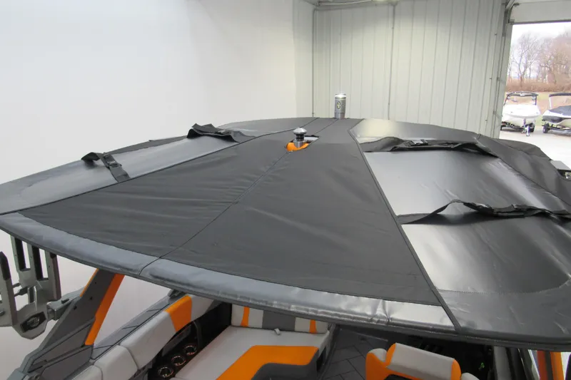 Slide: The Image of 2026 Malibu Wakesetter 23 LSV with protective cover in a storage facility. - 12