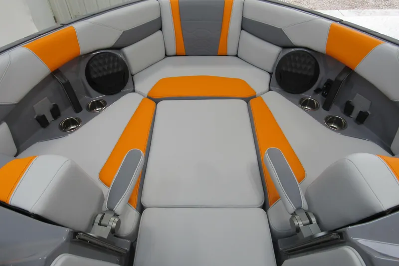 Slide: The Image of 2026 Malibu Wakesetter 23 LSV interior with orange and gray seating, cup holders, and speakers. - 17