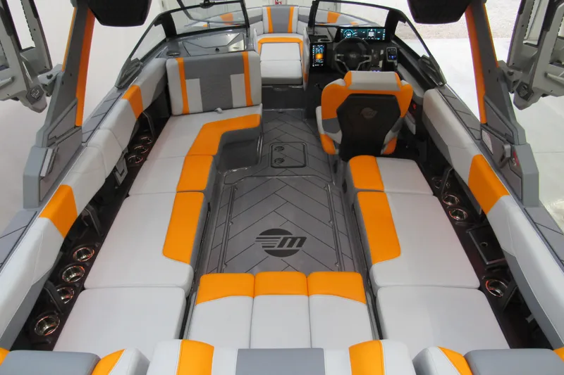 Slide: The Image of 2026 Malibu Wakesetter 23 LSV interior with orange and gray seating, modern dashboard. - 3