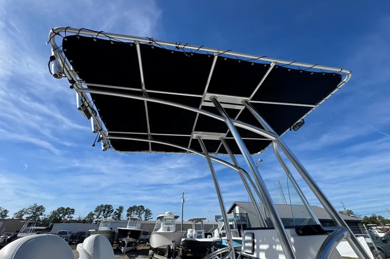Slide: The Image of 2013 Sundance DX22 boat with T-top against a clear blue sky. - 15