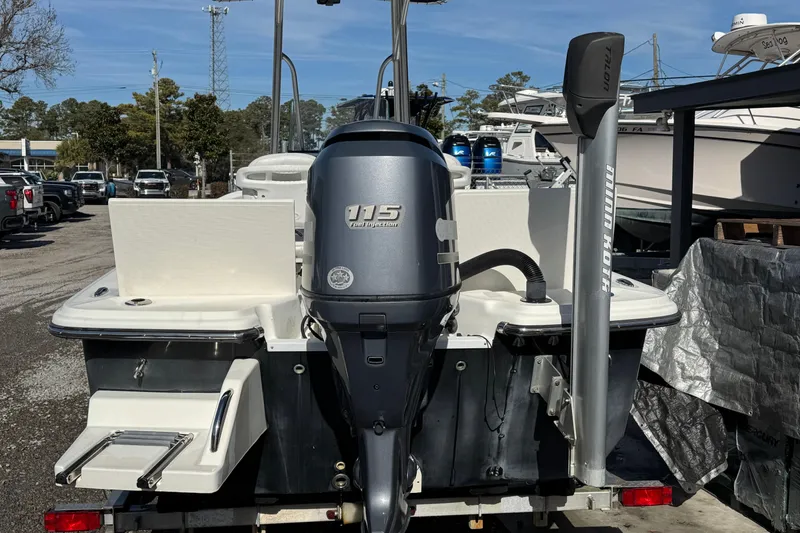 Slide: The Image of 2013 Sundance DX22 boat with 115 HP engine, parked outdoors. - 3