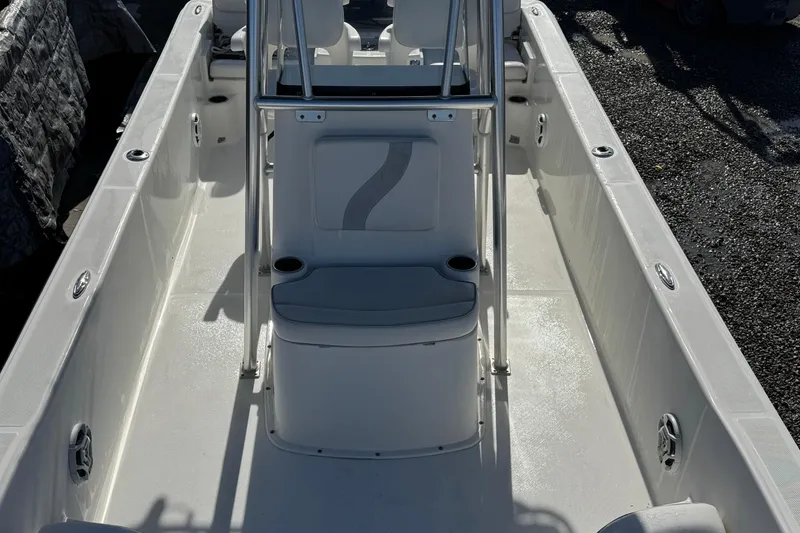 Slide: The Image of 2013 Sundance DX22 boat interior with seating and console, showcasing clean design. - 9