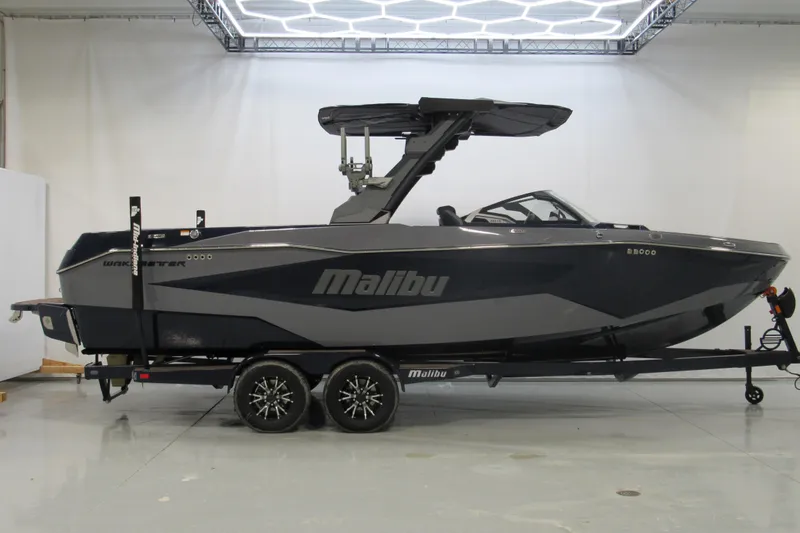 The Image of 2026 Malibu Wakesetter 25 LSV boat on trailer in showroom setting. - 0