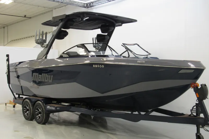 Slide: The Image of 2026 Malibu Wakesetter 25 LSV boat on trailer in indoor showroom. - 1