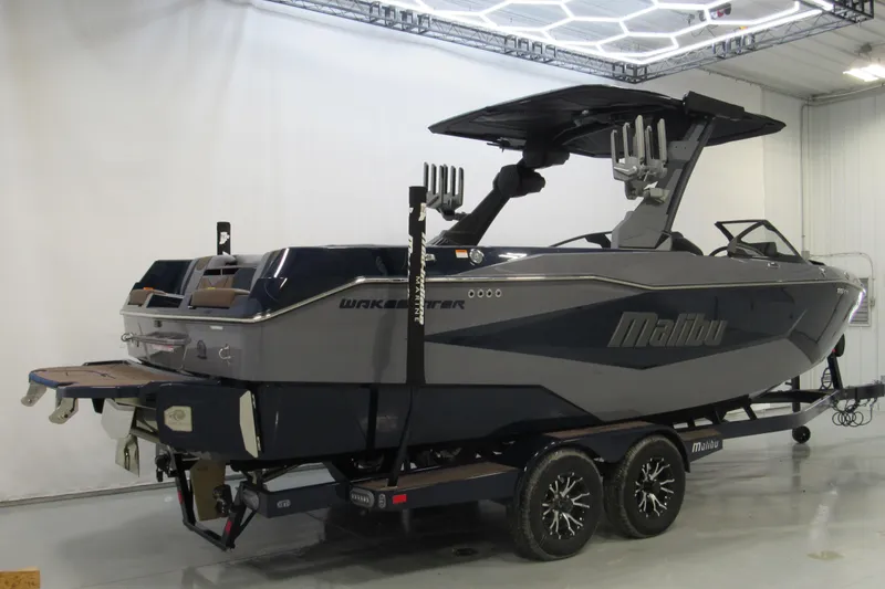 Slide: The Image of 2026 Malibu Wakesetter 25 LSV boat in showroom, side view on trailer. - 2
