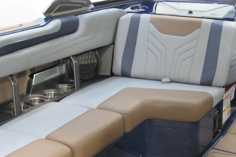 Slide: The Image of 2026 Malibu Wakesetter 25 LSV interior with luxurious seating and cup holders. - 6