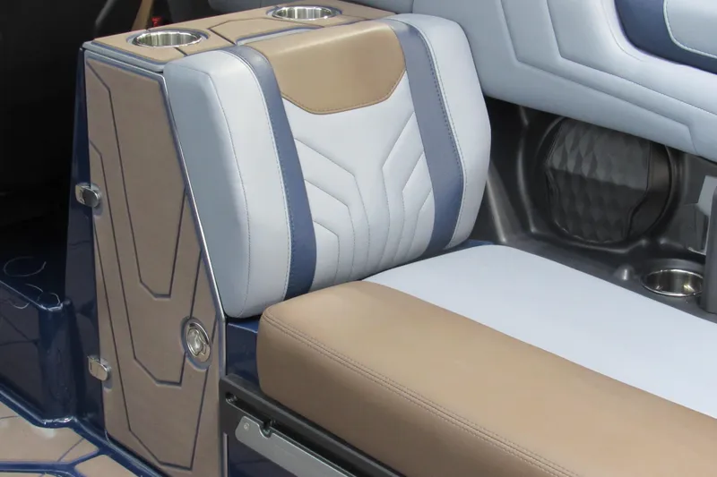 Slide: The Image of 2026 Malibu Wakesetter 25 LSV interior with beige and blue seating, featuring cup holders. - 7