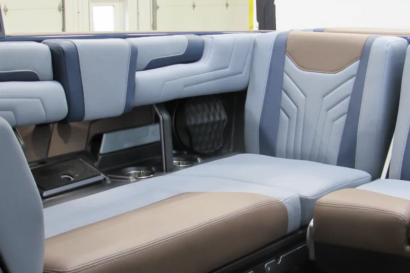 Slide: The Image of 2026 Malibu Wakesetter 25 LSV interior with stylish blue and brown seating. - 8