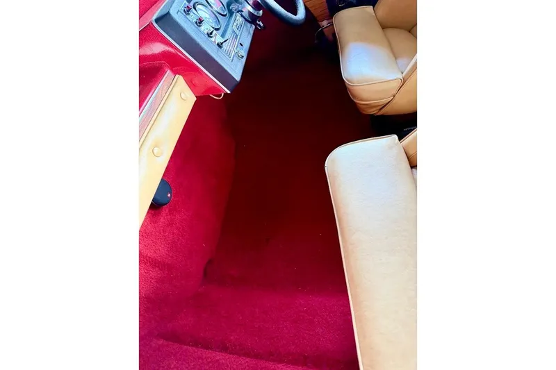 Slide: The Image of 1981 Glastron/Carlson C-512 interior with red carpet and beige seats. - 14