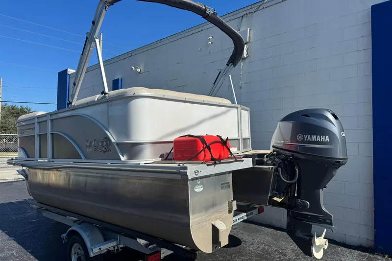 Slide: The Image of 2022 SunCatcher Select 16C pontoon boat with Yamaha outboard motor on trailer. - 1