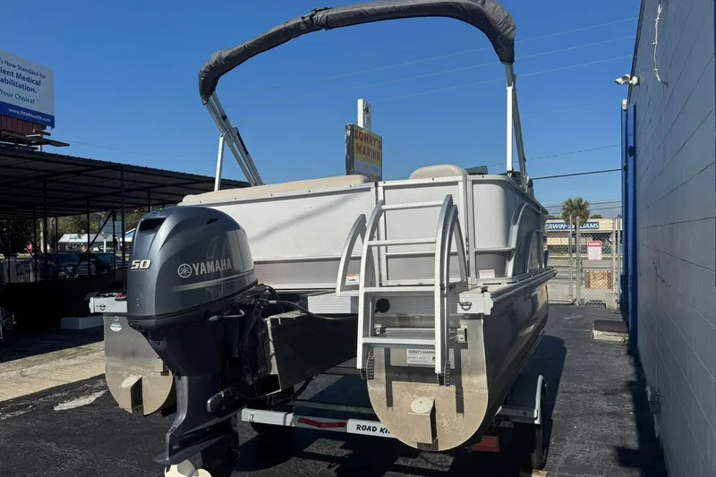 Slide: The Image of 2022 SunCatcher Select 16C pontoon boat with Yamaha 50 engine, parked outdoors. - 2