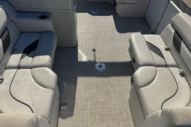 Slide: The Image of Interior of 2022 SunCatcher Select 16C pontoon boat with beige seating and carpeted floor. - 5