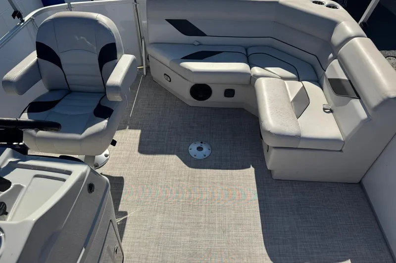 Slide: The Image of Interior of 2022 SunCatcher Select 16C pontoon boat with gray seating and flooring. - 6
