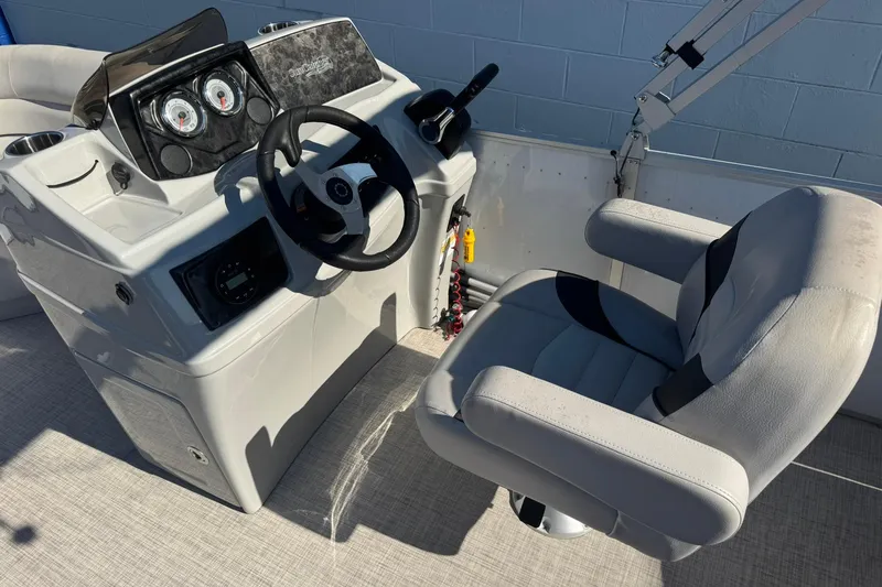 Slide: The Image of 2022 SunCatcher Select 16C boat console with steering wheel and captain's chair. - 7