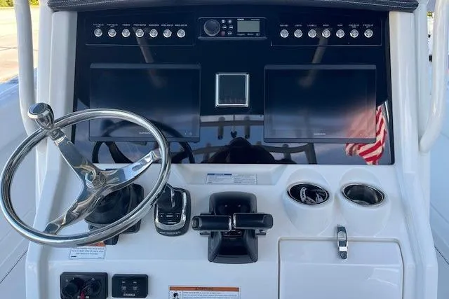 Slide: The Image of 2020 World Cat 280 CC-X boat dashboard with steering wheel and control panel. - 6