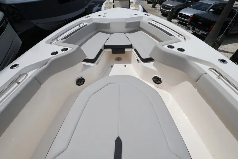 Slide: The Image of The image shows the bow area of a Boston Whaler 330 Outrage with gray cushions. - 35