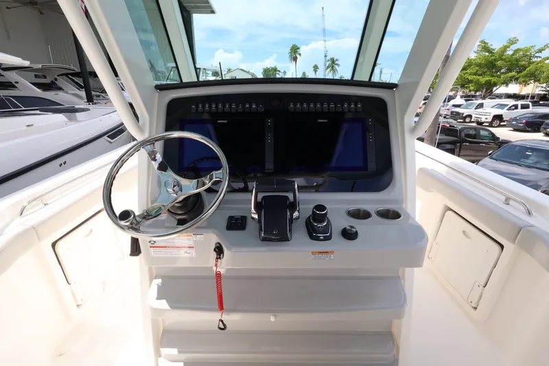 Slide: The Image of Helm of a Boston Whaler 330 Outrage with modern steering wheel and electronics. - 22