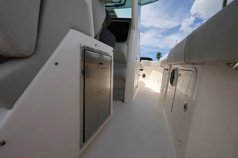 Slide: The Image of The image shows the interior of a Boston Whaler 330 Outrage boat with seating and storage. - 19