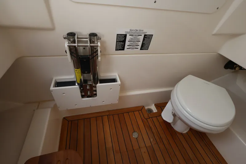 Slide: The Image of Interior of a boat cabin with wooden flooring and a toilet. - 33