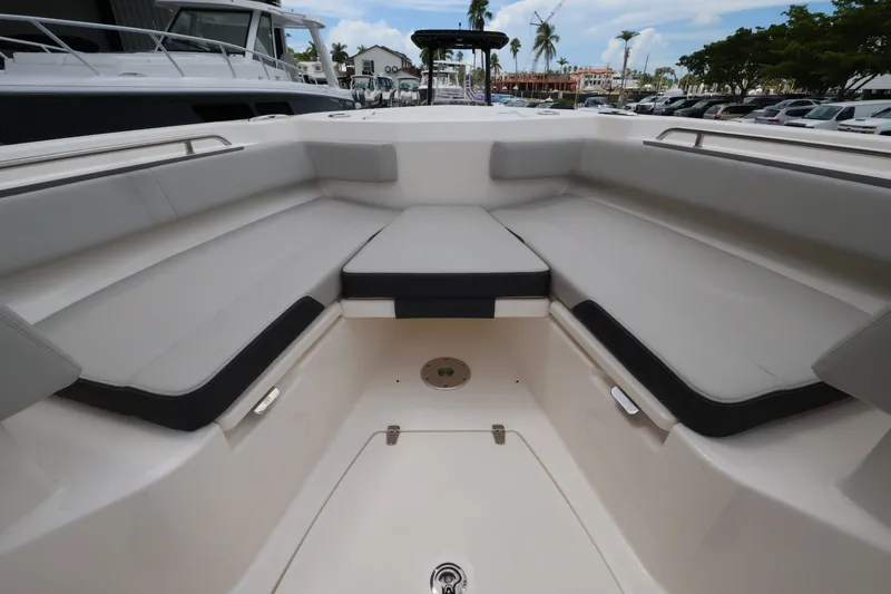 Slide: The Image of The image shows the bow area of a Boston Whaler 330 Outrage with cushioned seating. - 40