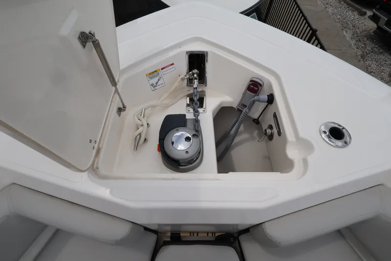 Slide: The Image of The anchor locker of the 2026 Boston Whaler 330 Outrage is open, revealing the windlass. - 45