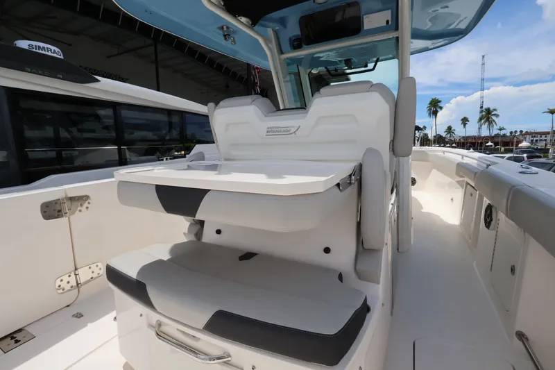 Slide: The Image of The image shows the cockpit of a 2026 Boston Whaler 330 Outrage with white seating and a table. - 15