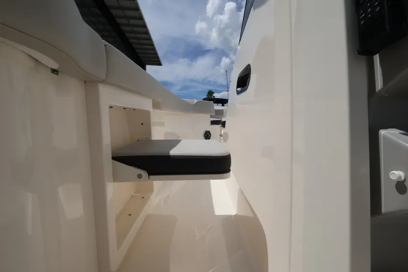 Slide: The Image of The 2026 Boston Whaler 330 Outrage features a clean, modern interior with a foldable seat. - 28