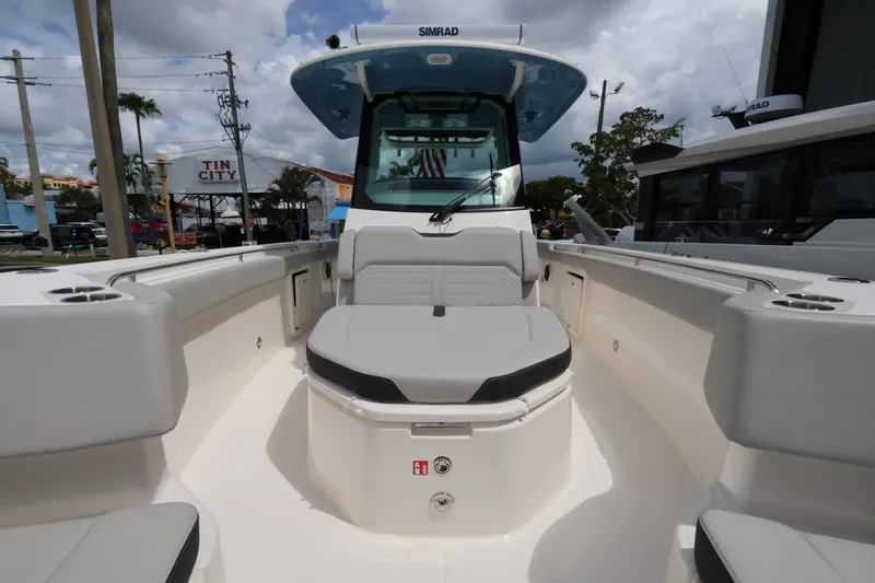 Slide: The Image of Boston Whaler 330 Outrage 2026: Spacious deck with seating area and modern electronics. - 36