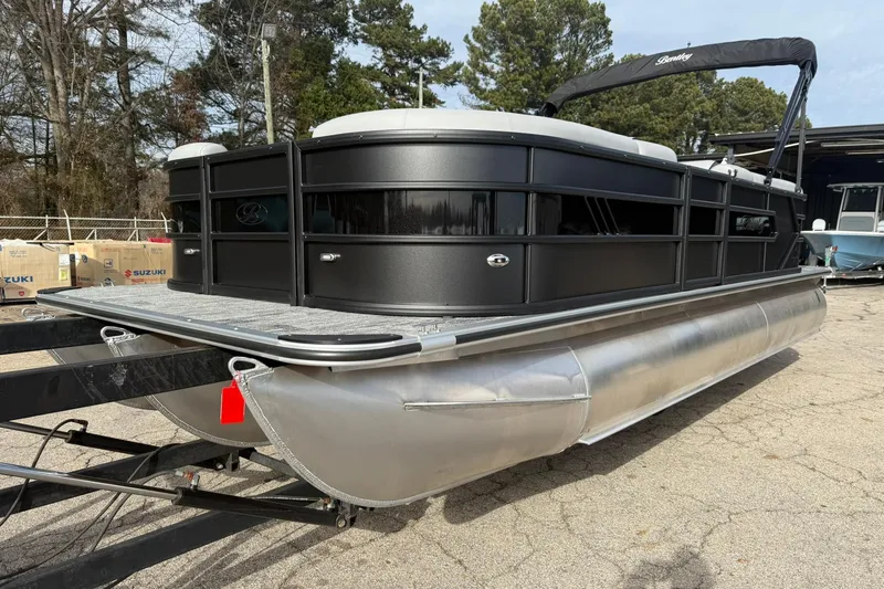 The Image of 2026 Bentley Pontoons Bolt 223 on trailer, sleek black design, outdoor setting. - 0