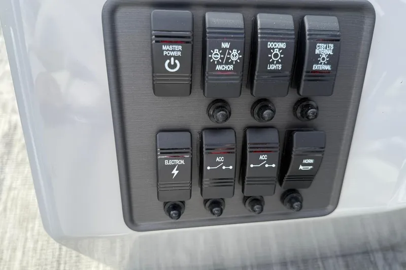 Slide: The Image of Control panel of 2026 Bentley Pontoons Bolt 223 with various switches and buttons. - 14