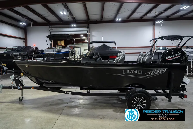 Slide: The Image of 2026 Lund 1700 Explorer SS boat in showroom with Mercury engine. - 10