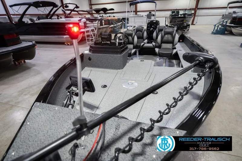 Slide: The Image of 2026 Lund 1700 Explorer SS boat in showroom, featuring modern design and seating. - 11