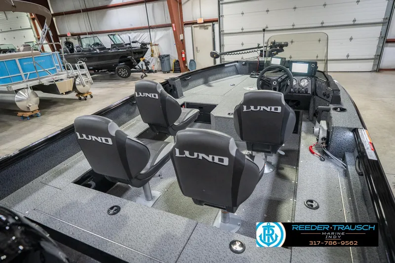Slide: The Image of 2026 Lund 1700 Explorer SS boat interior with three seats in a showroom. - 13