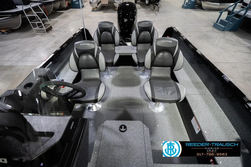 Slide: The Image of 2026 Lund 1700 Explorer SS boat interior with four seats in showroom. - 19