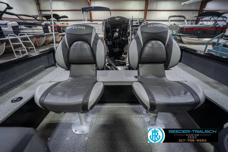 Slide: The Image of 2026 Lund 1700 Explorer SS boat interior with two gray seats in showroom. - 20