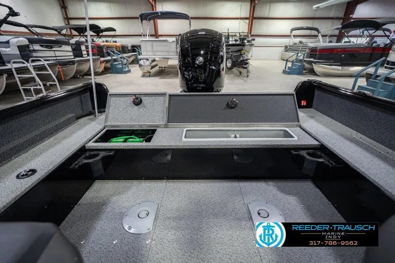 Slide: The Image of 2026 Lund 1700 Explorer SS boat interior with storage compartments in a showroom. - 23
