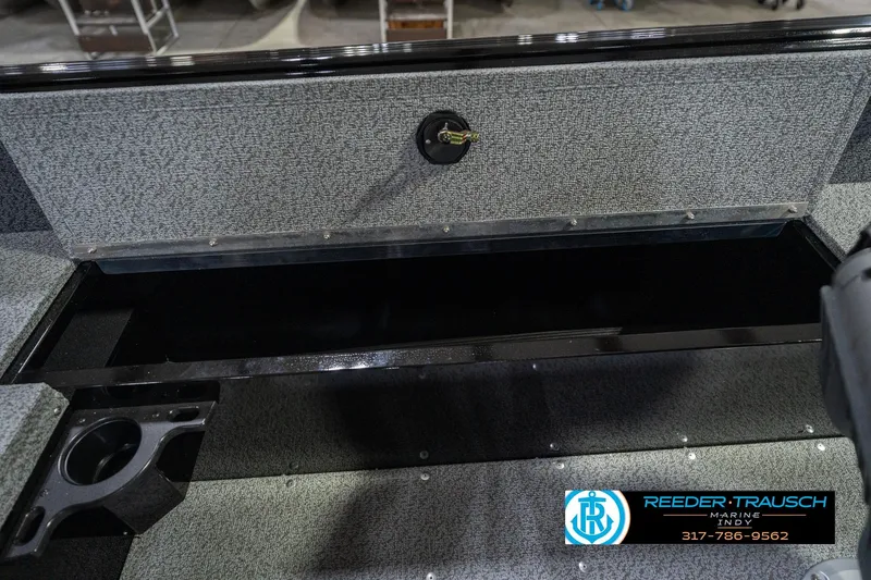 Slide: The Image of 2026 Lund 1700 Explorer SS boat interior storage compartment with cup holder. - 25