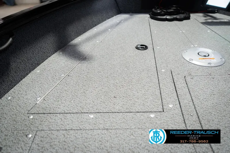 Slide: The Image of Interior view of 2026 Lund 1700 Explorer SS boat, featuring textured flooring and storage compartments. - 28