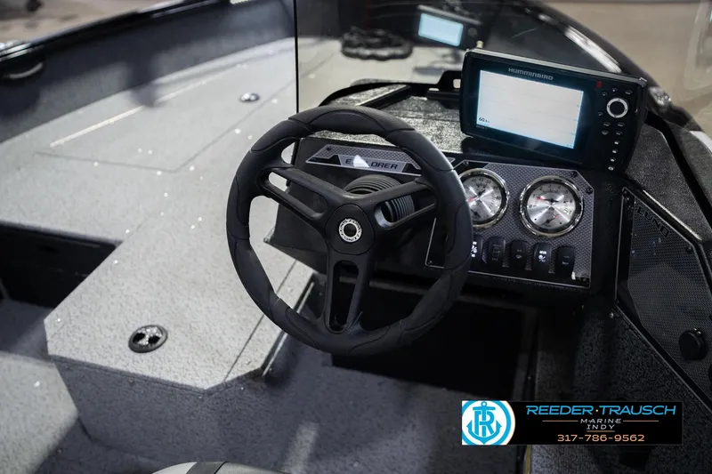 Slide: The Image of 2026 Lund 1700 Explorer SS boat dashboard with steering wheel and navigation display. - 30