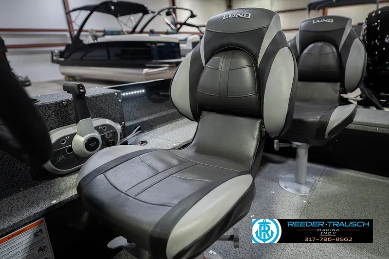 Slide: The Image of 2026 Lund 1700 Explorer SS boat interior with comfortable seating and control panel. - 38